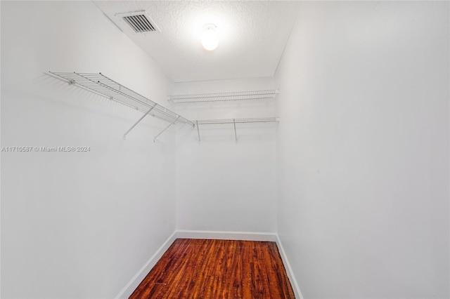 spacious closet with hardwood / wood-style flooring