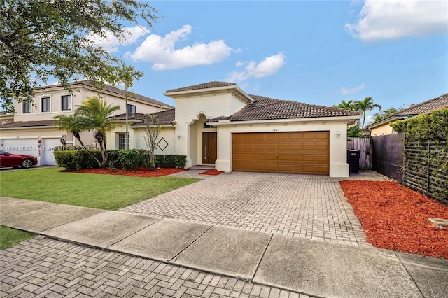 mediterranean / spanish-style home with a front yard and a garage