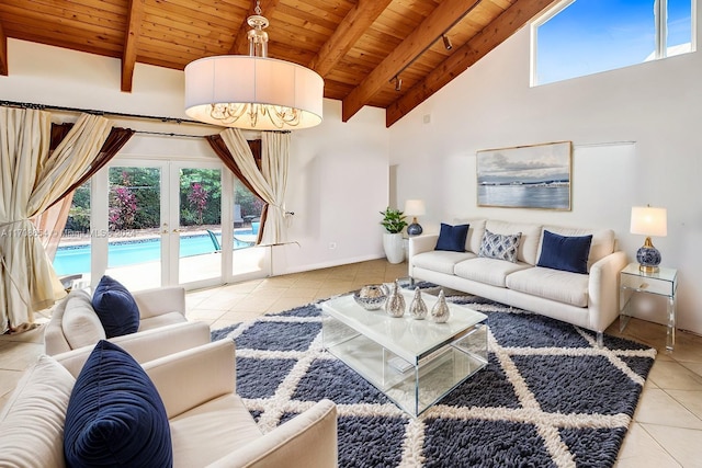 tiled living room featuring beam ceiling, plenty of natural light, wood ceiling, and french doors