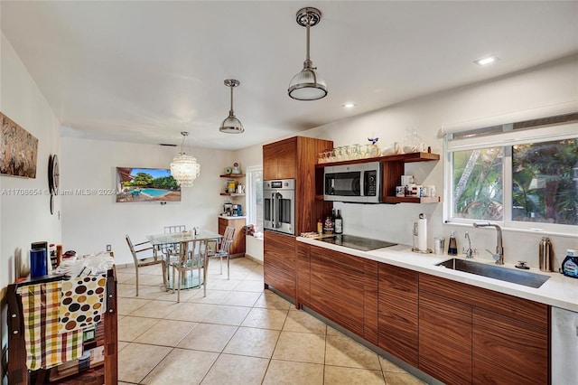 kitchen featuring pendant lighting, light tile patterned floors, sink, and stainless steel appliances