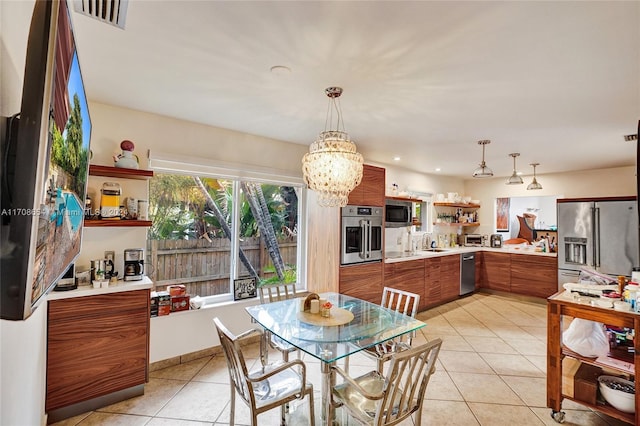 dining room with a notable chandelier, light tile patterned floors, and sink