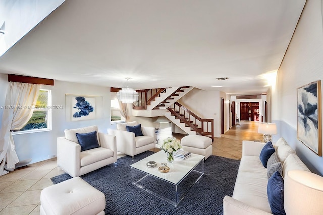 tiled living room featuring a notable chandelier