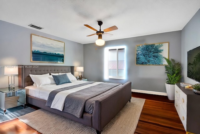 bedroom featuring ceiling fan and dark wood-type flooring