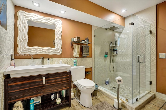 bathroom featuring toilet, vanity, tile patterned floors, and walk in shower