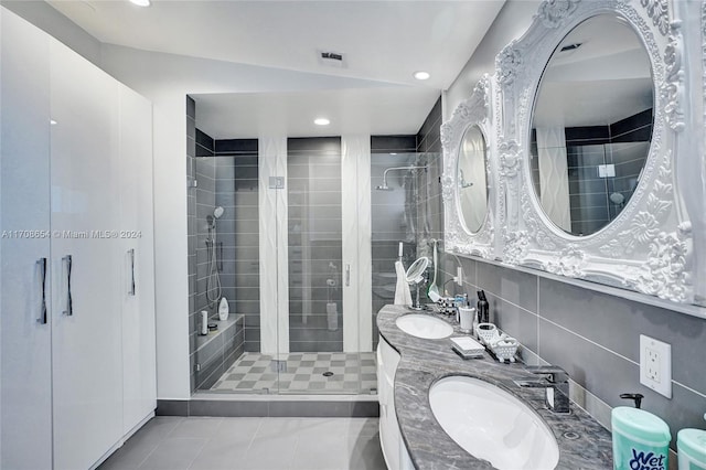 bathroom featuring tile patterned flooring, vanity, lofted ceiling, and a shower with shower door