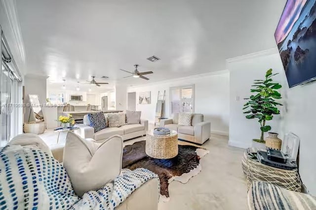 living room featuring crown molding and ceiling fan