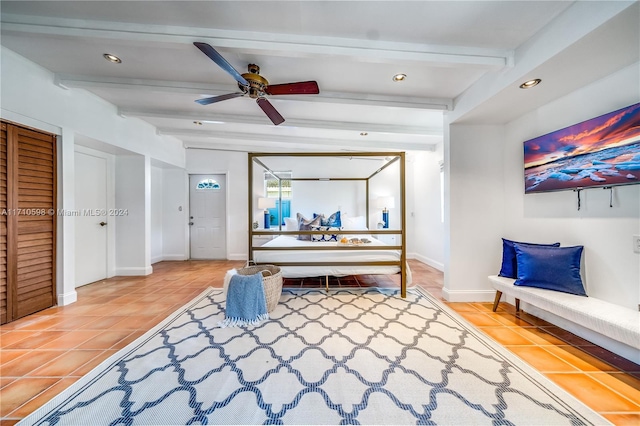 bedroom featuring tile patterned floors, ceiling fan, and beamed ceiling