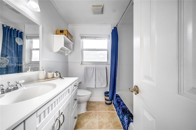 full bathroom featuring tile patterned flooring, crown molding, toilet, shower / tub combo with curtain, and vanity