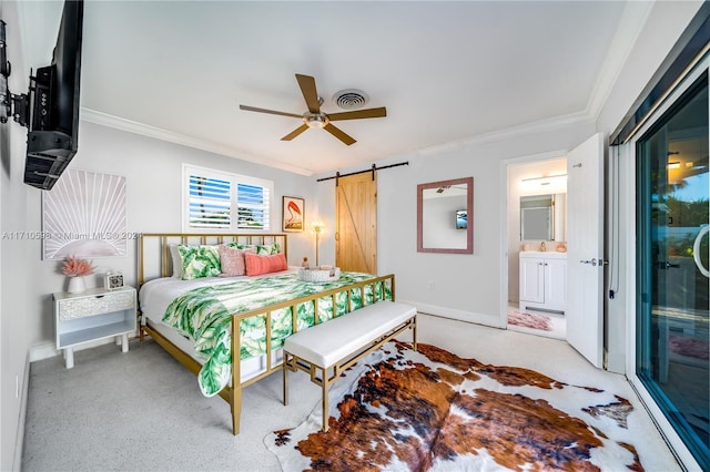 carpeted bedroom with a barn door, ceiling fan, crown molding, and ensuite bathroom