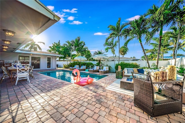 view of swimming pool with a fire pit and a patio area