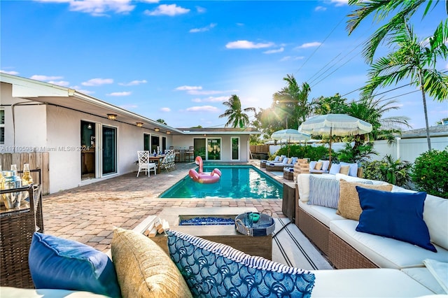 view of pool featuring an outdoor living space and a patio