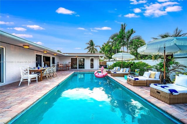 view of pool featuring outdoor lounge area and a patio area