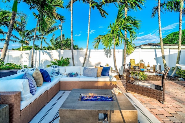 view of patio featuring an outdoor living space with a fire pit