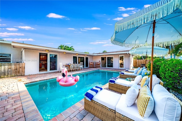 view of swimming pool featuring french doors, an outdoor hangout area, and a patio area