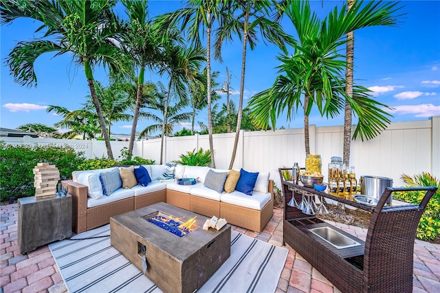 view of patio / terrace with an outdoor living space with a fire pit