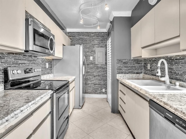 kitchen featuring crown molding, sink, light tile patterned floors, and appliances with stainless steel finishes