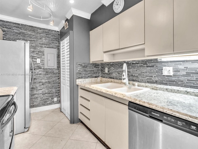 kitchen featuring backsplash, sink, ornamental molding, light tile patterned floors, and stainless steel appliances