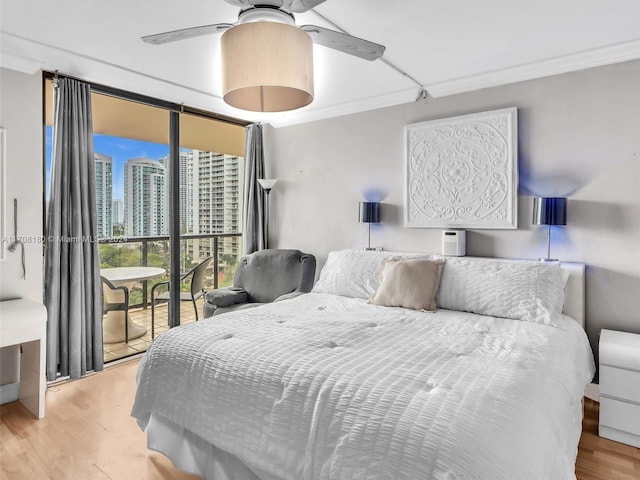 bedroom with ceiling fan, access to exterior, light wood-type flooring, and crown molding