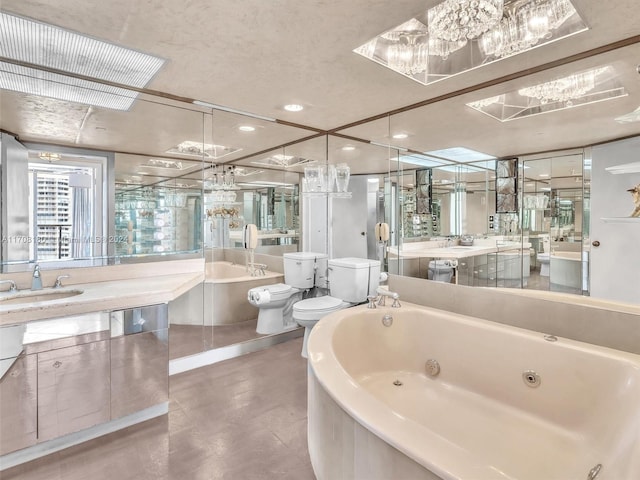 bathroom featuring a bathing tub, vanity, toilet, and a bidet