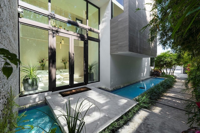 view of swimming pool featuring french doors