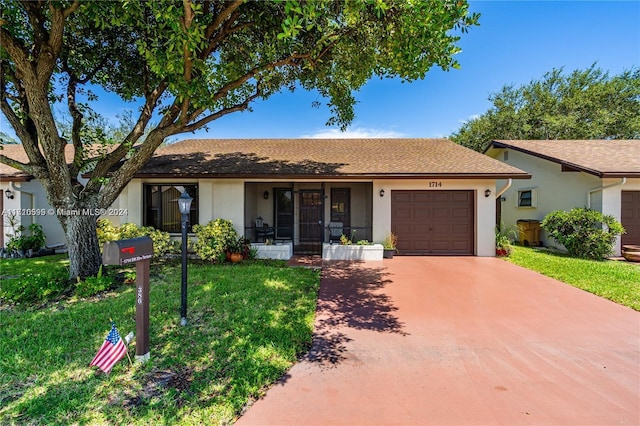 ranch-style house featuring a garage and a front yard