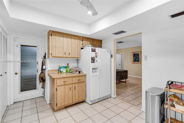 kitchen with ceiling fan, light brown cabinets, light tile patterned floors, and white refrigerator with ice dispenser