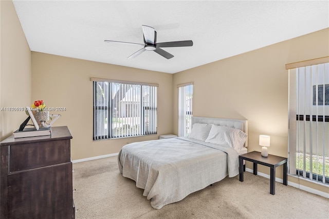 bedroom with ceiling fan and light colored carpet