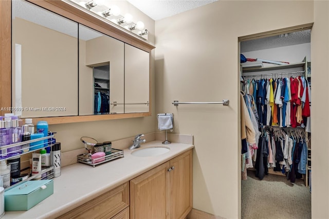 bathroom featuring vanity and a textured ceiling