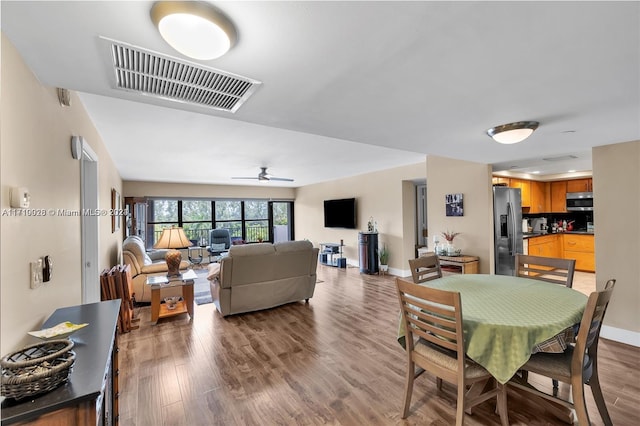 dining area featuring ceiling fan and wood-type flooring