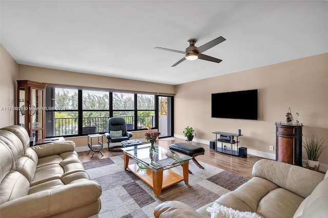 living room with ceiling fan and light hardwood / wood-style floors