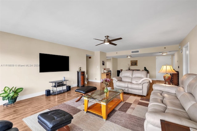 living room featuring ceiling fan and light wood-type flooring