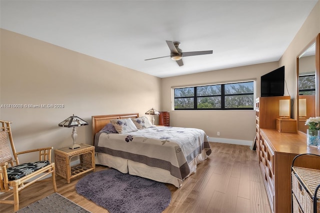 bedroom with light wood-type flooring and ceiling fan