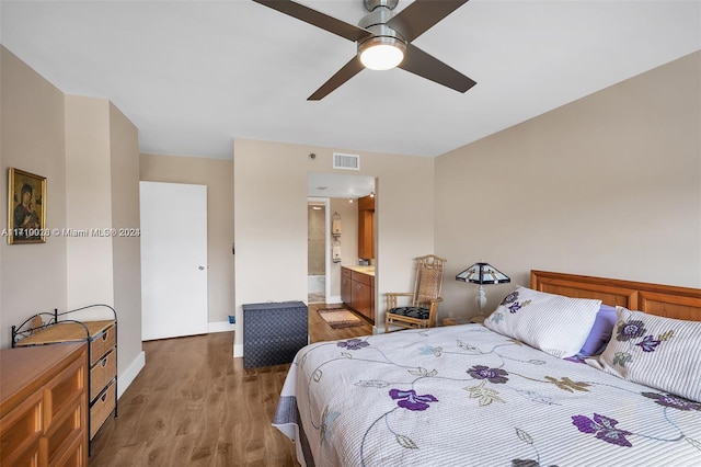 bedroom featuring connected bathroom, ceiling fan, and hardwood / wood-style floors