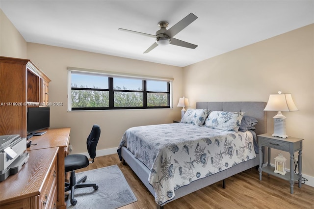 bedroom with ceiling fan and hardwood / wood-style floors