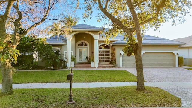 view of front of property with a front lawn and a garage