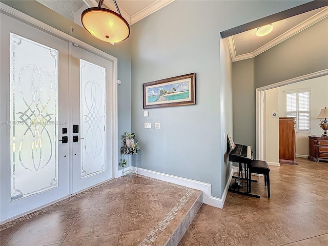 foyer entrance with french doors and crown molding