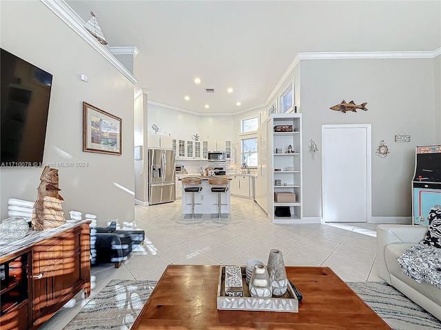 living room with light tile patterned floors and crown molding