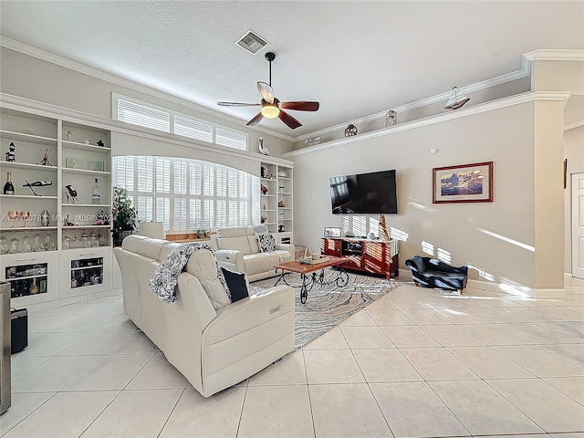 living room with ceiling fan, light tile patterned floors, and ornamental molding