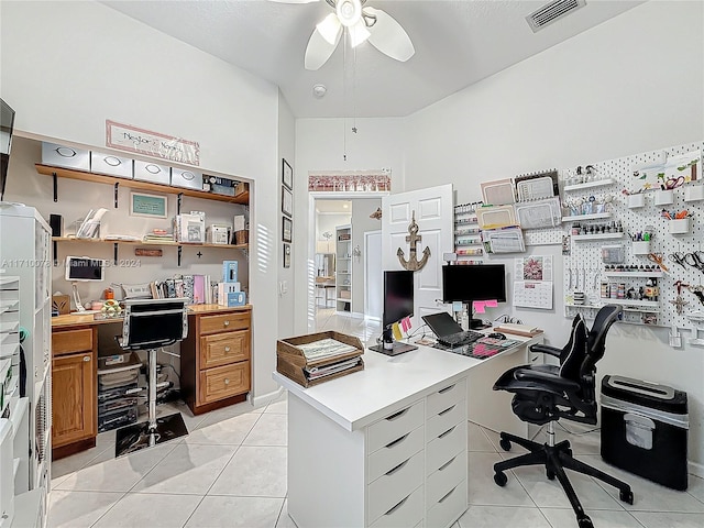 tiled office featuring a workshop area and ceiling fan