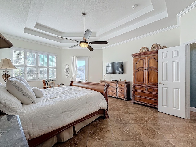 bedroom with a textured ceiling, ceiling fan, a raised ceiling, and crown molding