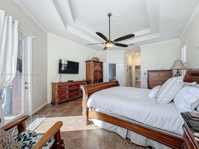 bedroom with a tray ceiling, ceiling fan, a textured ceiling, and ornamental molding