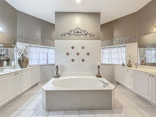 bathroom featuring a washtub, tile patterned floors, and a wealth of natural light