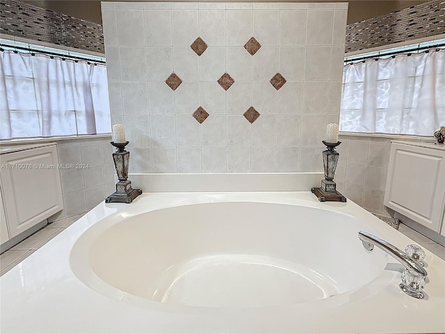 bathroom featuring a bath and a wealth of natural light