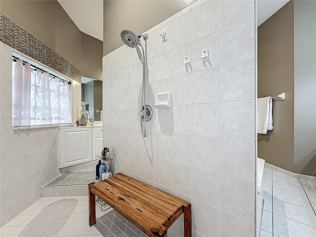 bathroom with tile patterned flooring and tiled shower