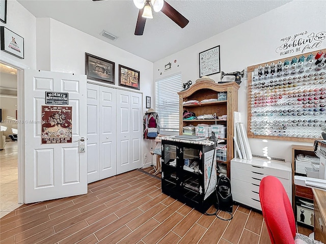 office with ceiling fan and a textured ceiling