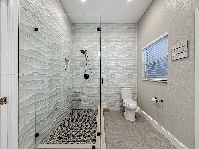 bathroom featuring toilet and walk in shower