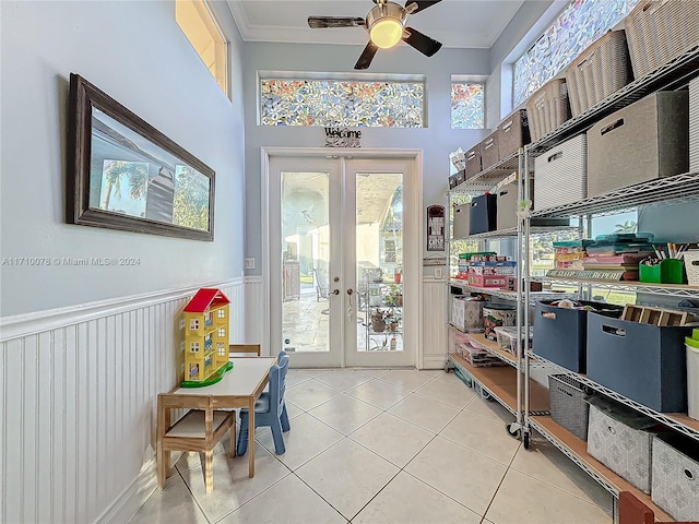 doorway featuring ceiling fan, french doors, light tile patterned floors, and ornamental molding