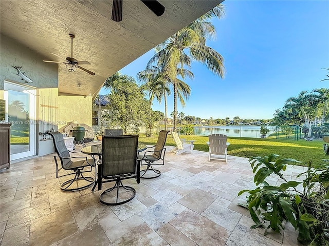 view of patio featuring ceiling fan and a water view