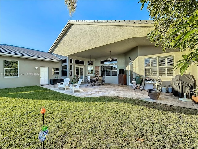 back of house with a patio, ceiling fan, and a lawn