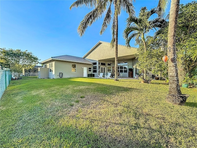 rear view of property with a yard